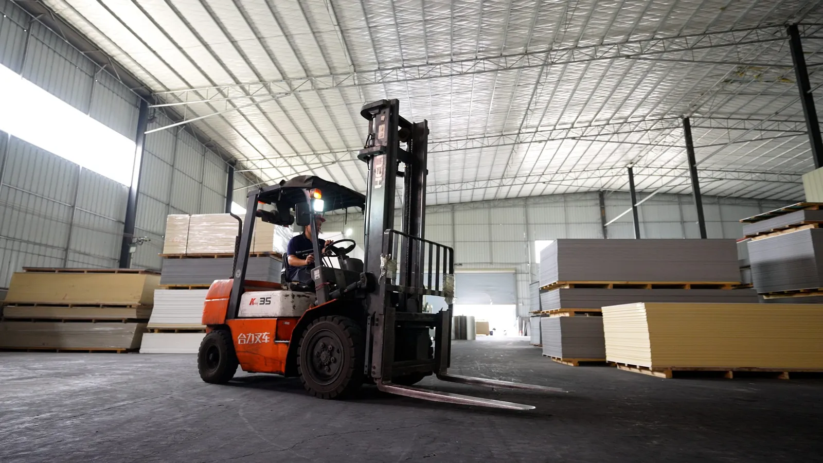 Forklift moving finished wall panels in the warehouse